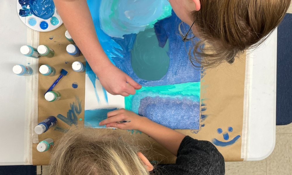 Two children painting together